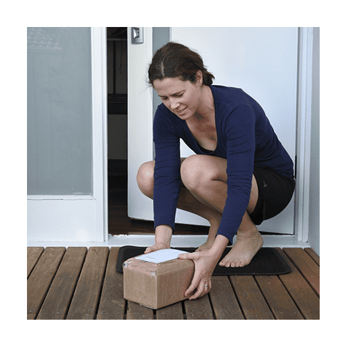 Woman grabbing a package that has been delivered